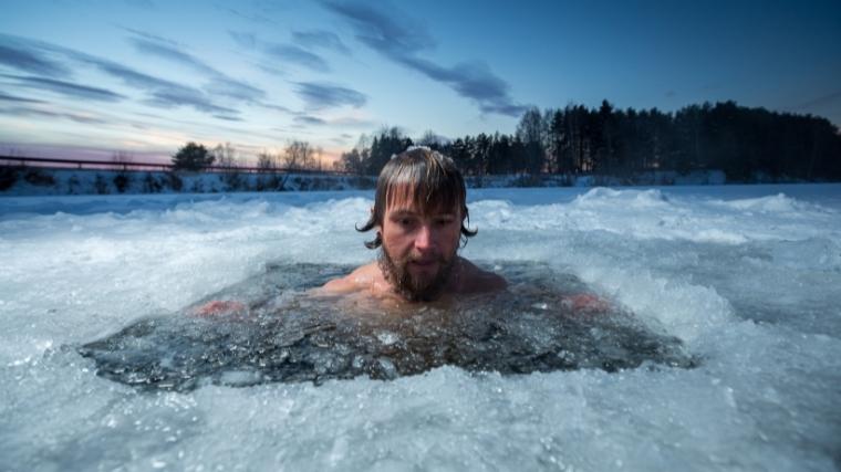 Man sitting in ice water