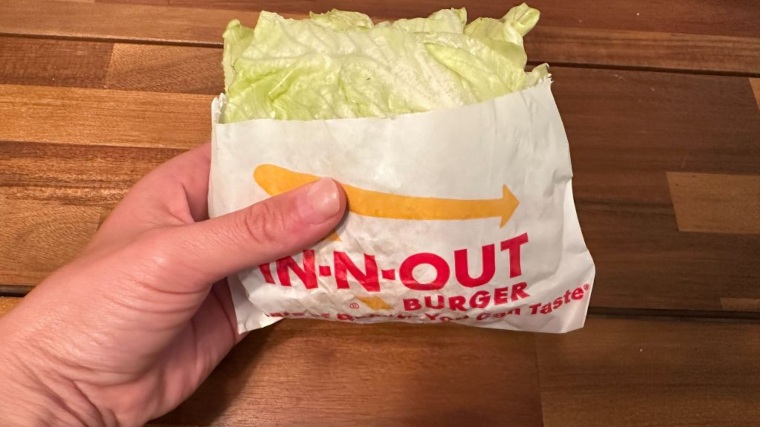 Our tester holds a protein-style In-N-Out Burger