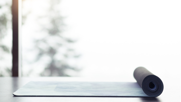 yoga mat beside winter window