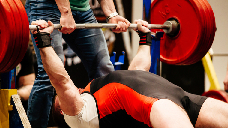 man holding bench press at lockout