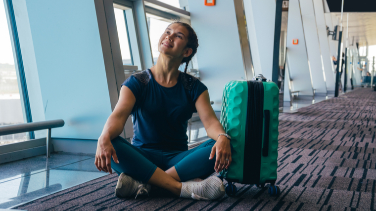 woman sitting on airport floor