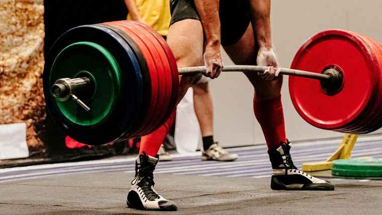 man pulling sumo deadlift