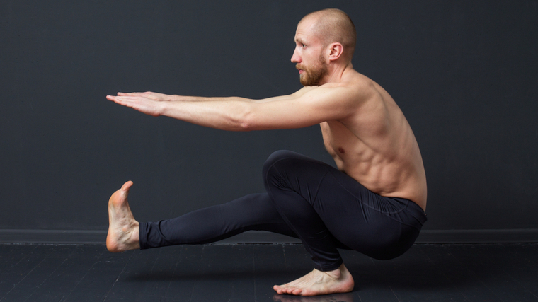 man performing pistol squat 