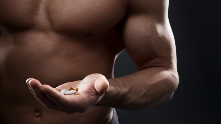 Man holding a palm-full of pills