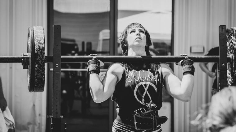 Cara Brennan pressing axle bar overhead