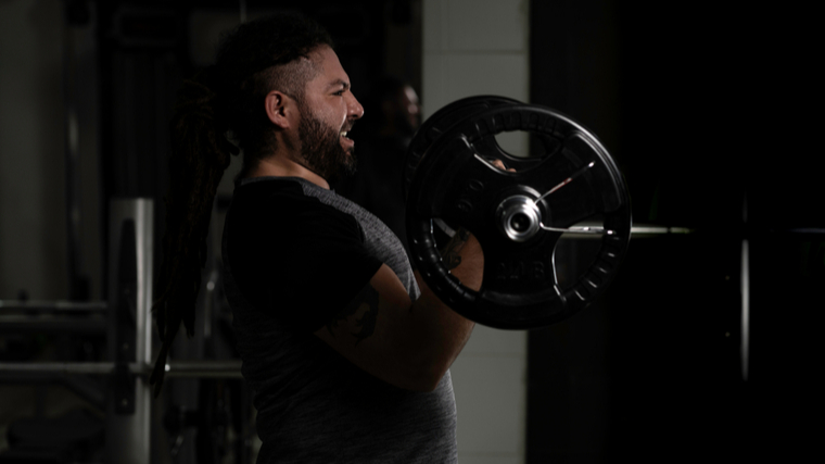 A person performs a barbell curl.