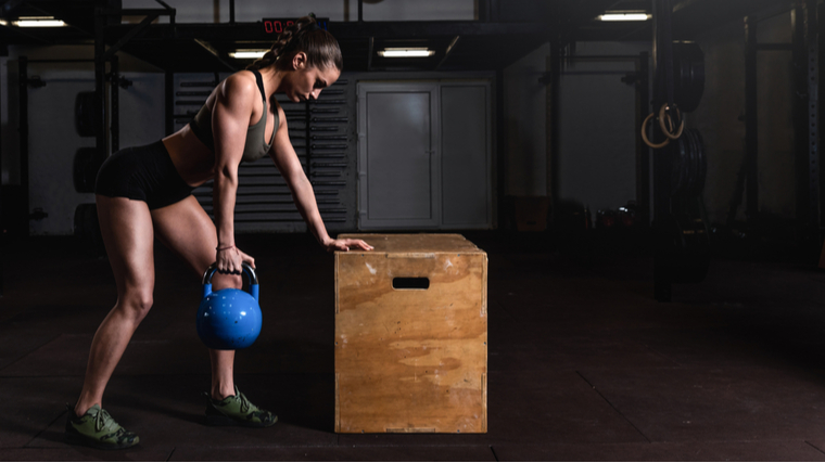 woman doing kettlebell row 