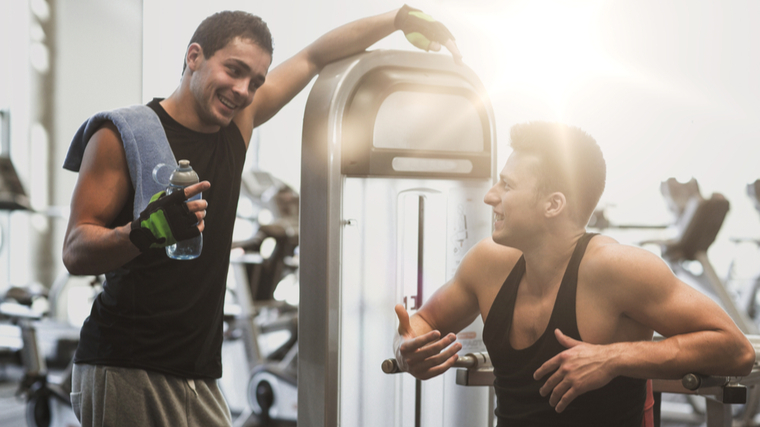 two people conversing in gym 