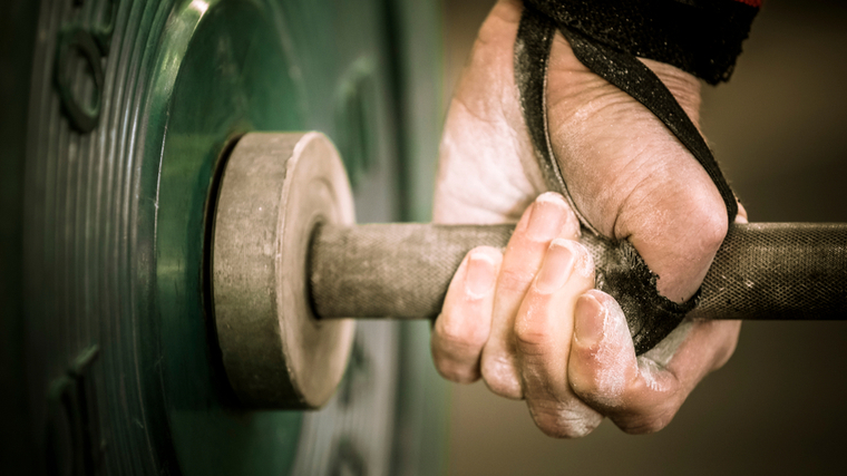 A close up of a hand setting up a hook grip.