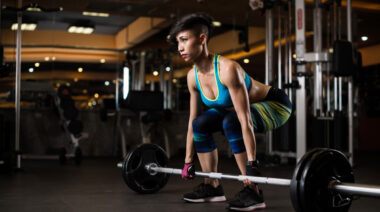 A person prepares to perform a deadlift.