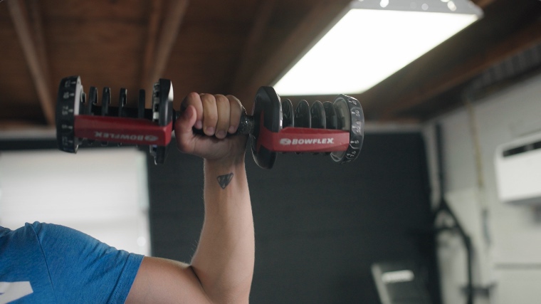 BarBend's Jake Herod training with a Bowflex adjustable dumbbell.