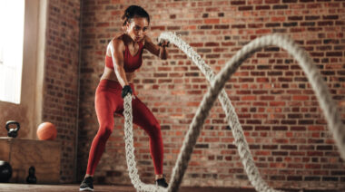 A person works out with battle ropes.