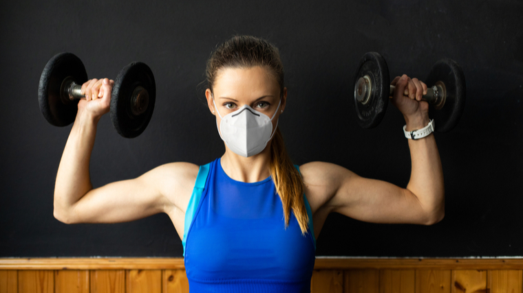 woman performing shoulder press 