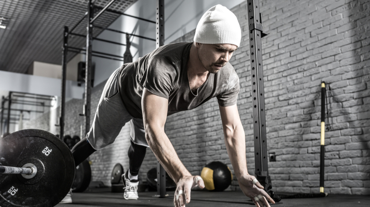 A person performs a plyometric pushup.