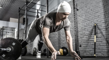 A person performs a plyometric pushup.