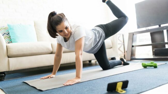 Woman working out in her living room floor