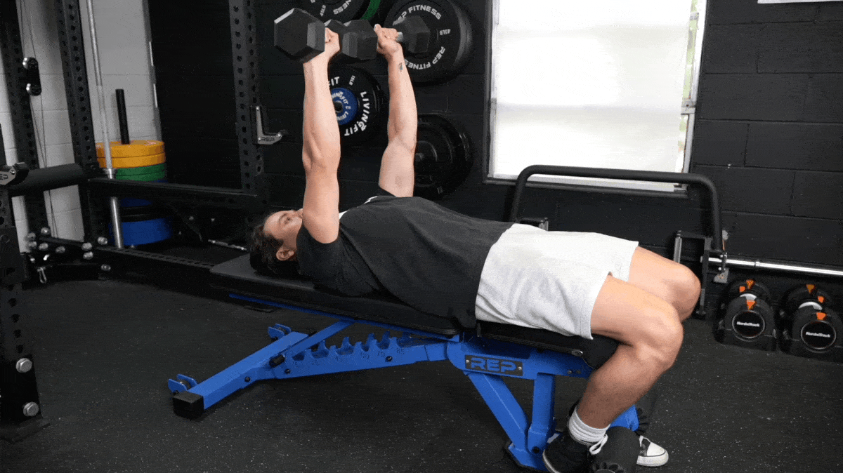 A person using dumbbells in doing bench presses.