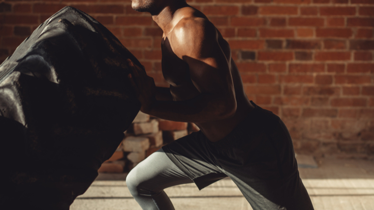 man performing tire flip