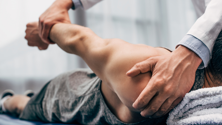 A patient gets adjusted by a chiropractor.