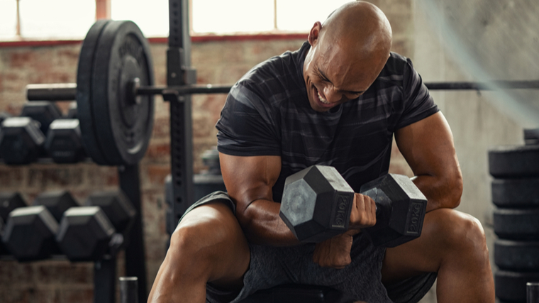 man performing concentration curl 