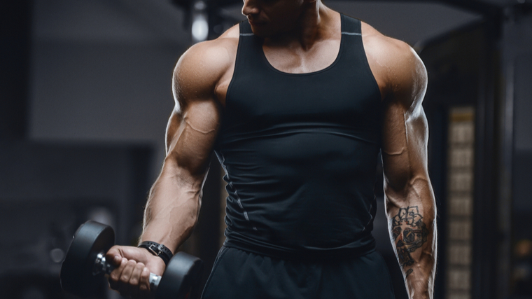 man performs dumbbell curl 