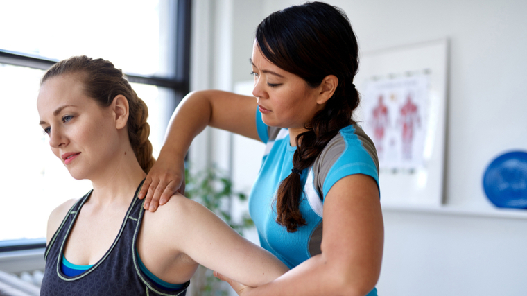 A chiropractor works on their patient.