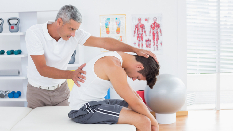 An athlete receives an adjustment from a chiropractor.