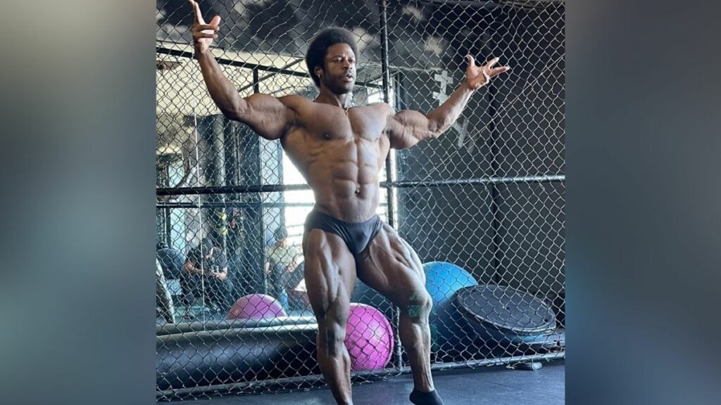 Bodybuilder Breon Ansley posing with his arms outstretched to his sides