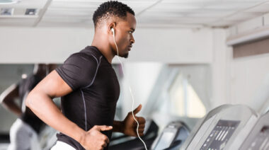 A person runs on a treadmill in the gym.