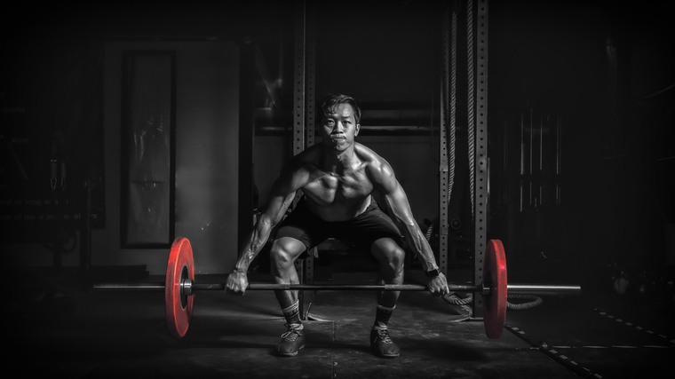 A person prepares to deadlift.