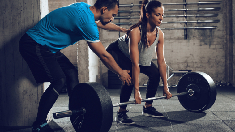 trainer spots deadlift 