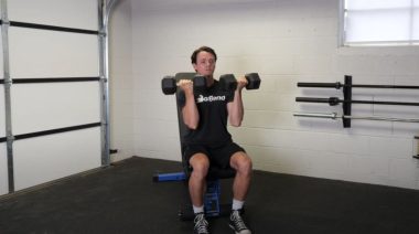 A person doing the Arnold press.