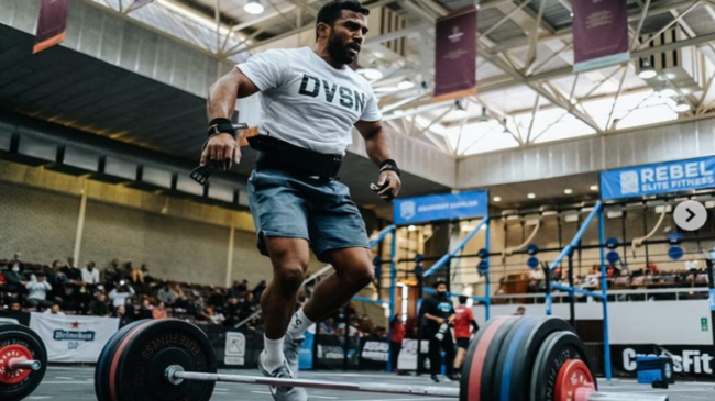 Kealan Henry hops sideways over a loaded barbell at the Fittest in Cape Town Semifinals.