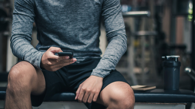 man looks at phone program 