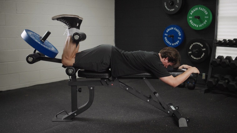 Jake Doing Leg Curls on the Force USA MyBench