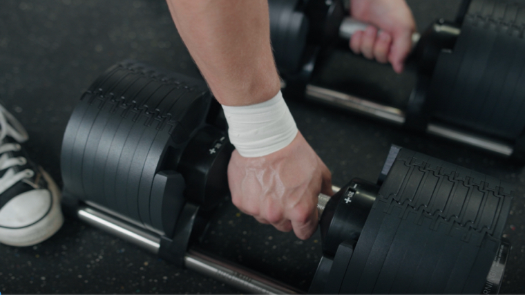 Removing the NÜOBELL Adjustable Dumbbells from their cradle