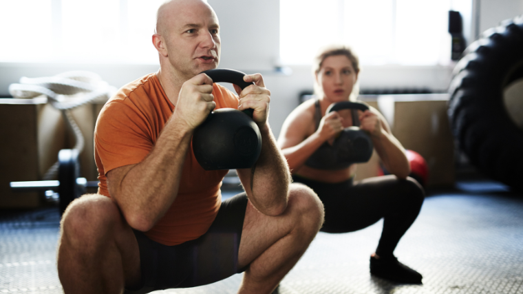 man performing goblet squat 