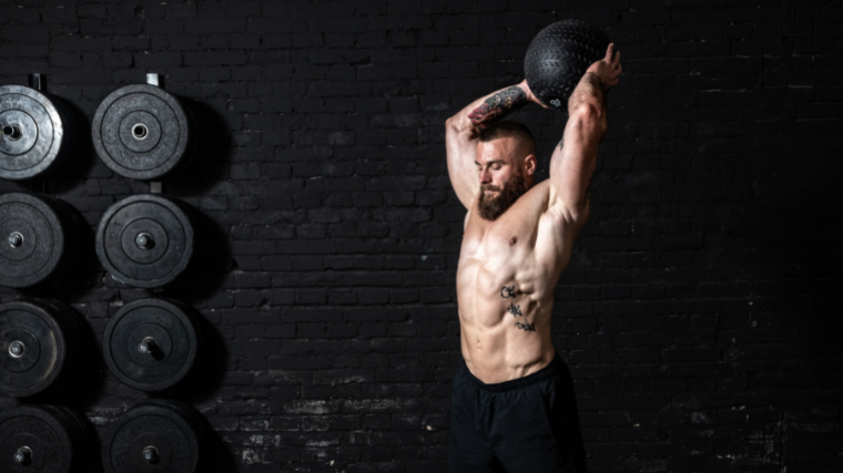 man performs medicine ball slam