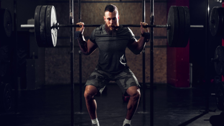 Man Squatting with Barbell