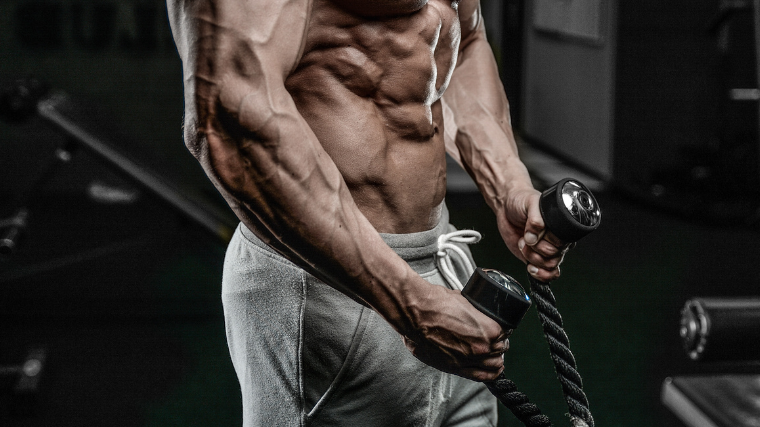 Man grips exercise rope during cable curl