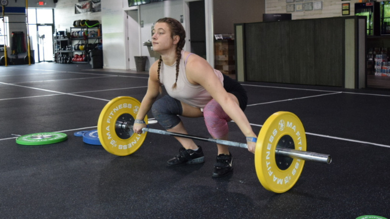 weightlifter prepares to perform the snatch