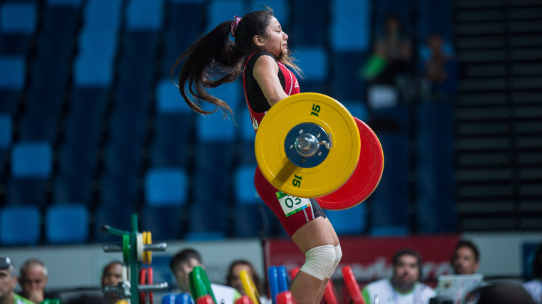 Elite weightlifter cleans during competition