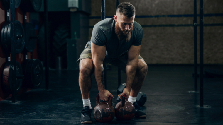 man performs kettlebell deadlift