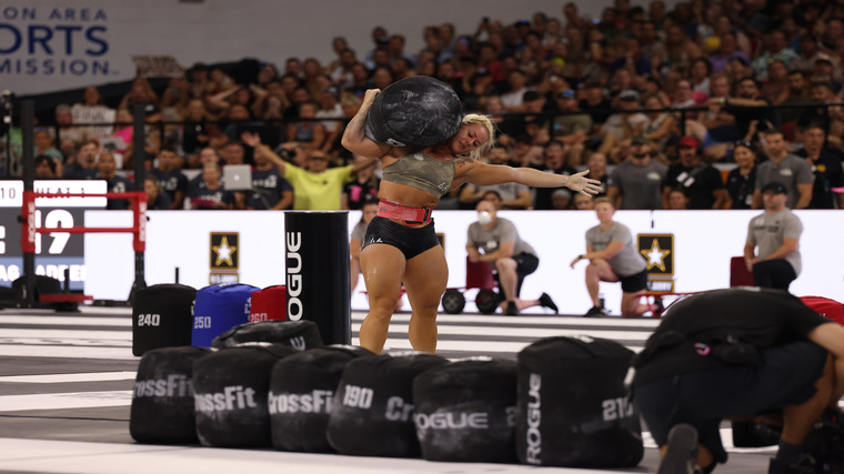 Dani Speegle successfully lifts a sandbag to her shoulder at the 2022 CrossFit Games.