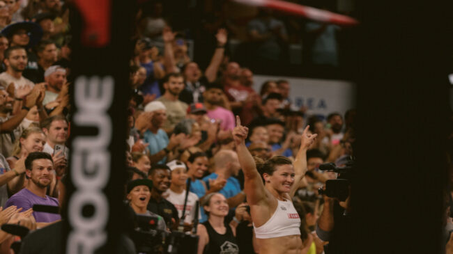Tia-Clair Toomey holds up her arms to acknowledge the crowd after winning the title of Fittest Woman on Earth® for the sixth time.