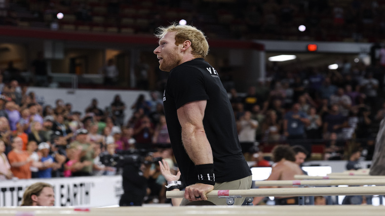 Patrick Vellner holds the top of a parallel bar dip at the 2022 CrossFit Games.
