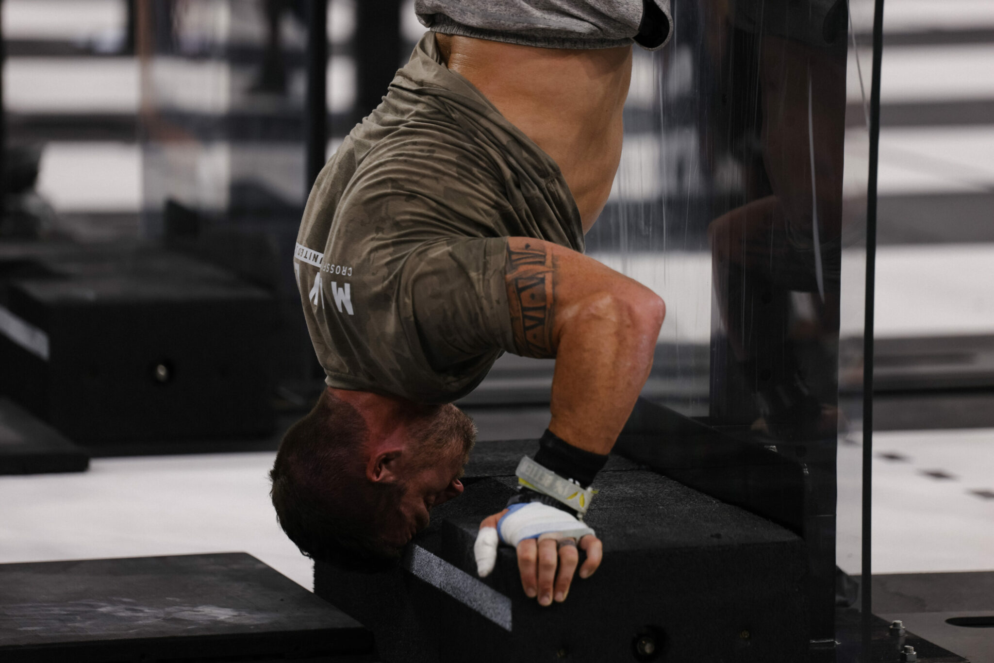 Will Moorad performs wall-facing deficit handstand push-ups.