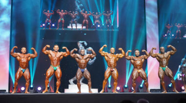 A group of bodybuilders posing on a stage.