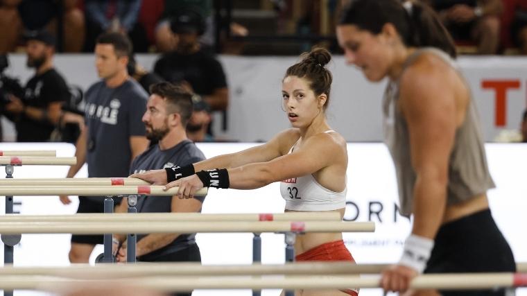 Emma Lawson staring into the camera as athletes pass her by in Event 4 of the 2022 CrossFit Games