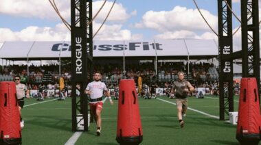 Ricky Garard and Patrick Vellner running on turf, outside, at the 2022 CrossFit Games.